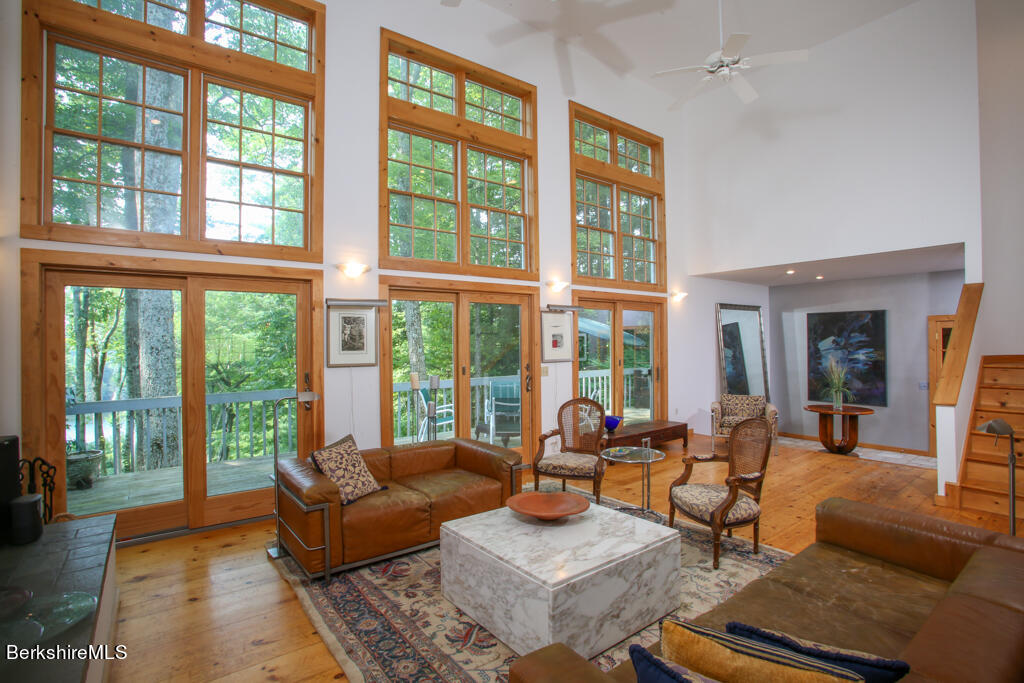 142 Main Road Monterey, MA 01230 - Photo 12 of 32 a living room with furniture and floor to ceiling windows