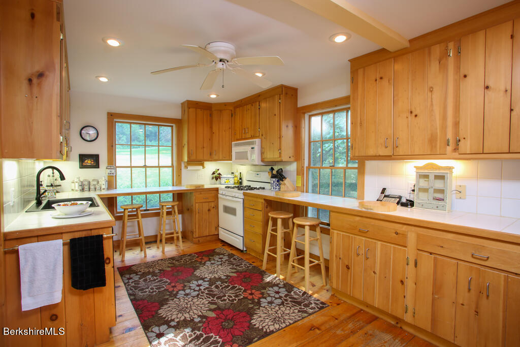 142 Main Road Monterey, MA 01230 - Photo 15 of 32 a kitchen with sink refrigerator and cabinets