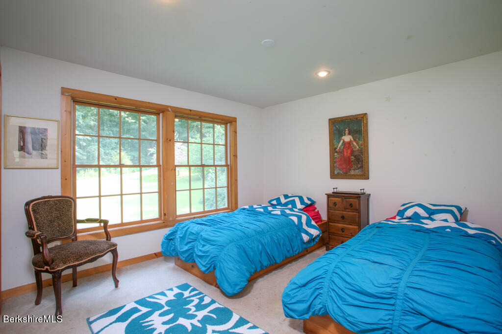 142 Main Road Monterey, MA 01230 - Photo 23 of 32 a bedroom with two beds and a chair