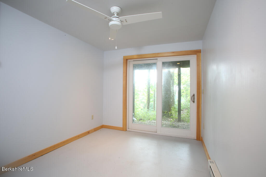 142 Main Road Monterey, MA 01230 - Photo 25 of 32 an empty room with an entryway and a window