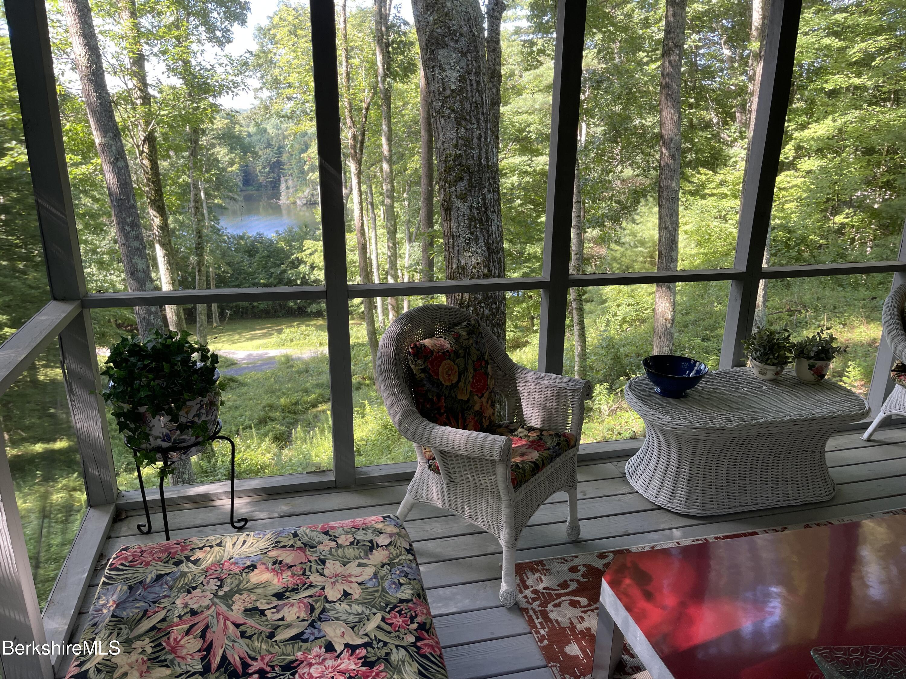 142 Main Road Monterey, MA 01230 - Photo 3 of 32 a view of a porch with furniture and floor to ceiling window