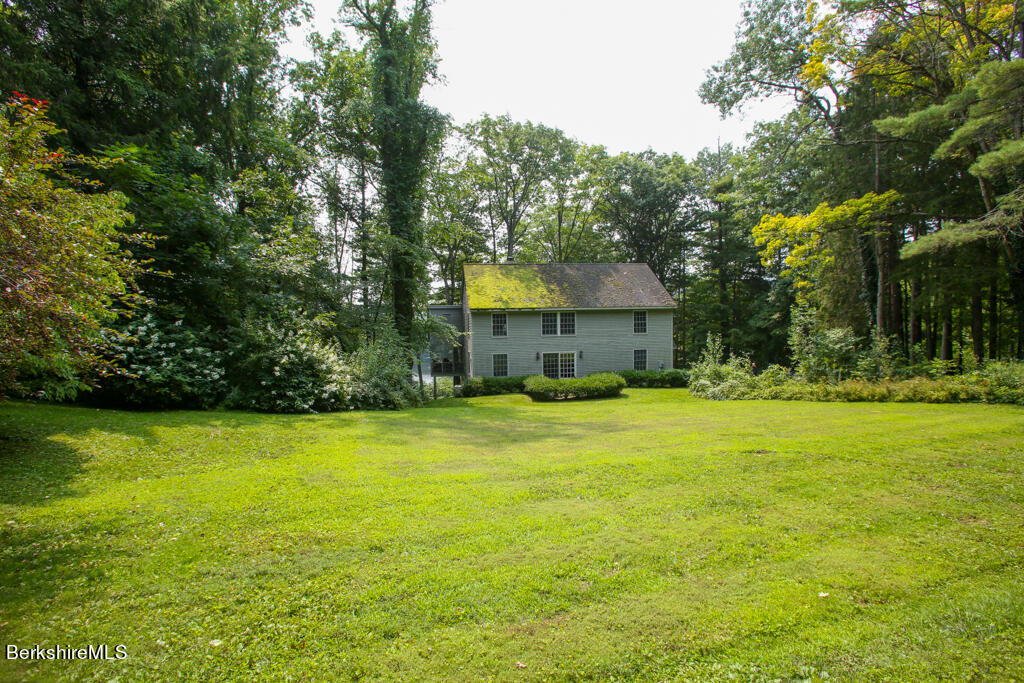 142 Main Road Monterey, MA 01230 - Photo 9 of 32 a front view of a house with a big yard