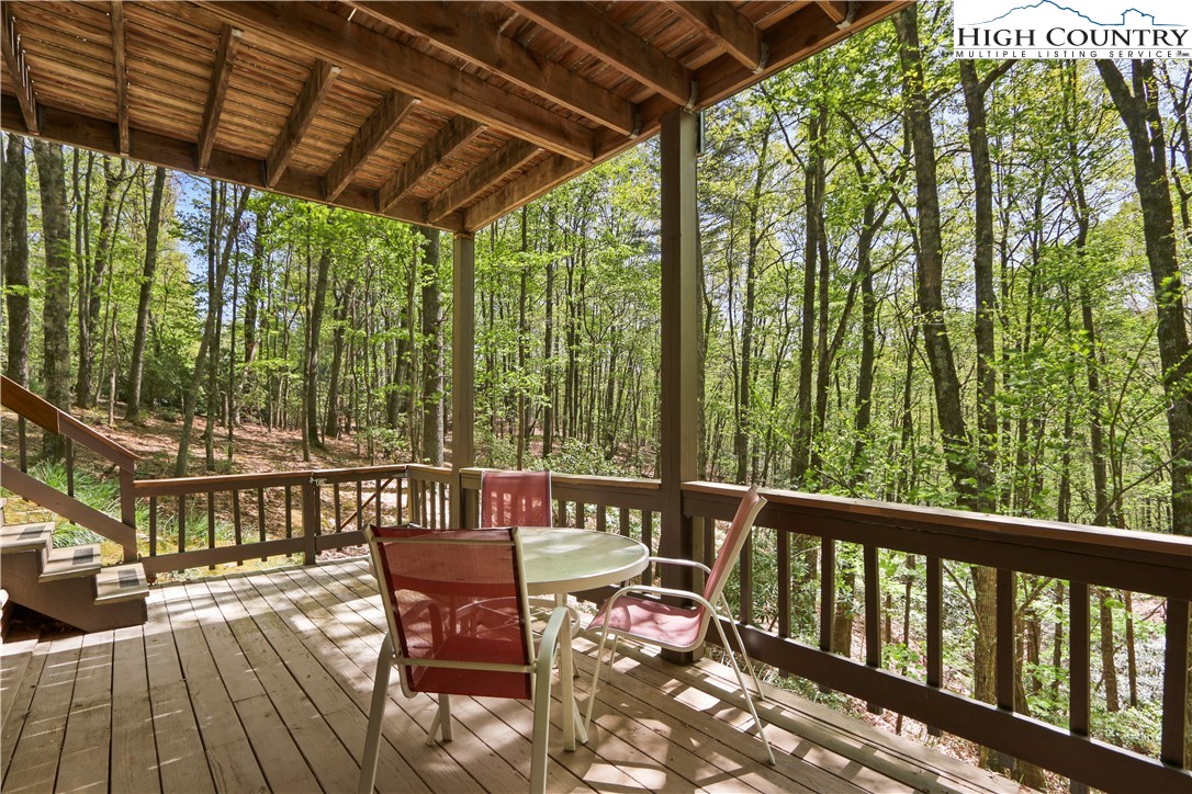 845 Trout Lake Road Deep Gap, NC 28618 - Photo 2 of 38 a view of a chairs and table in the balcony