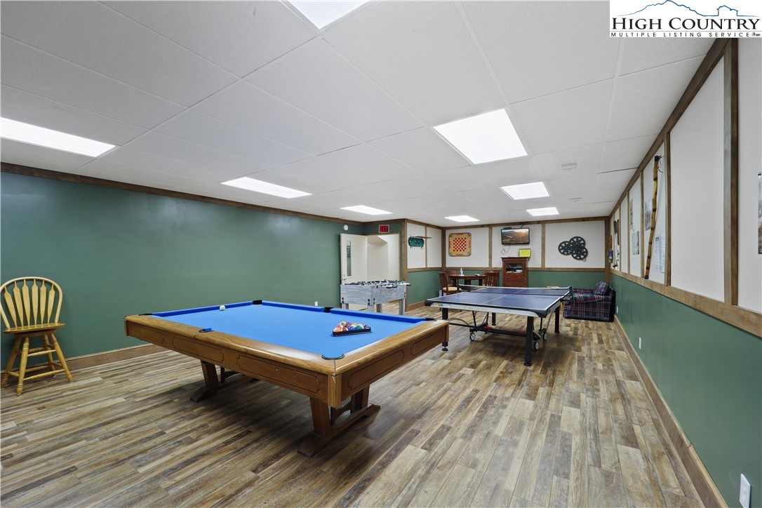 845 Trout Lake Road Deep Gap, NC 28618 - Photo 33 of 38 a room with furniture pool table wooden floor and windows