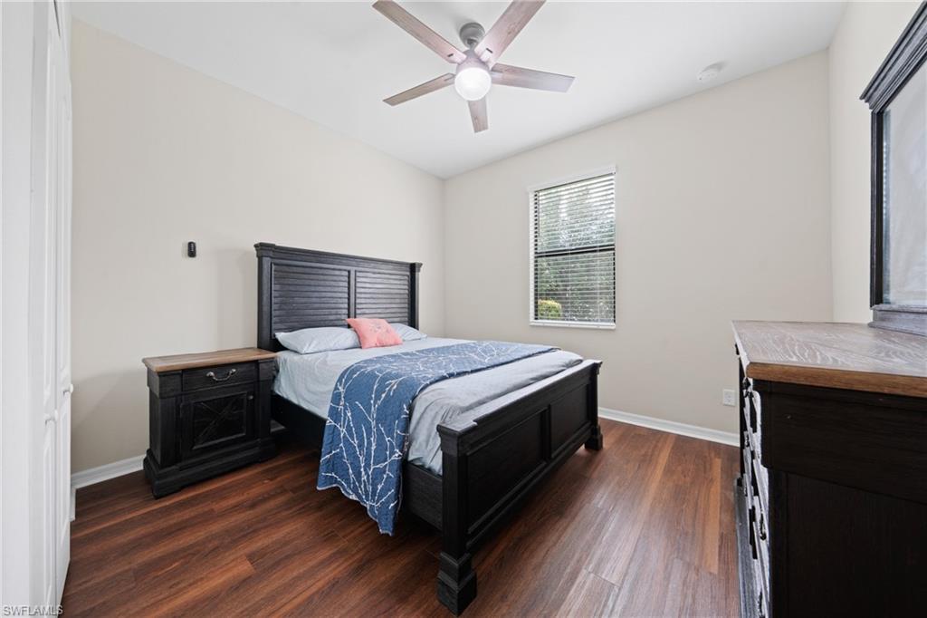4228 Raffia Palm Circle Naples, FL 34119 - Photo 21 of 50 Bedroom with dark wood-style flooring and a ceiling fan