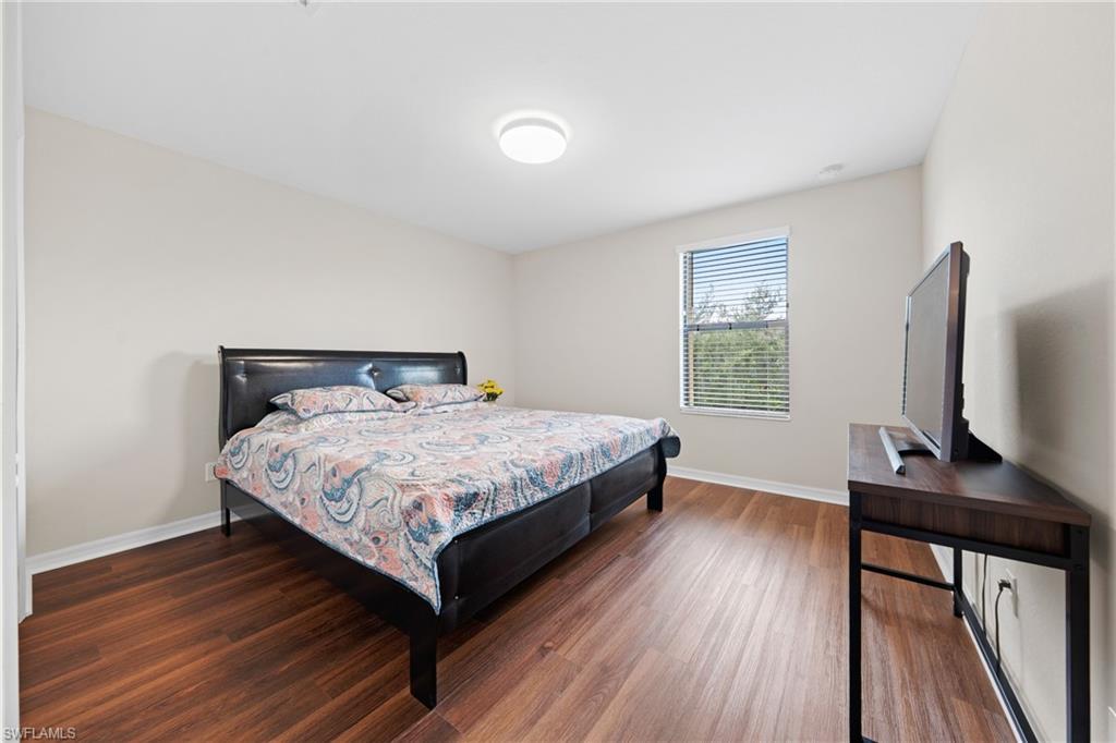 4228 Raffia Palm Circle Naples, FL 34119 - Photo 23 of 50 Bedroom with wood finished floors and baseboards
