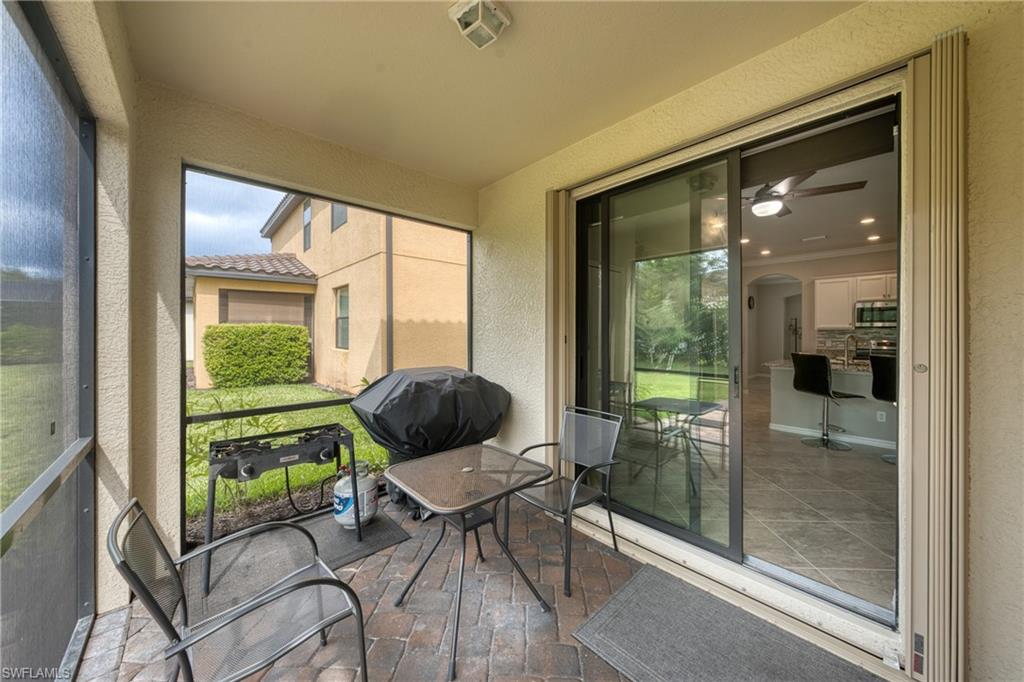 4228 Raffia Palm Circle Naples, FL 34119 - Photo 32 of 50 Sunroom with ceiling fan and arched walkways
