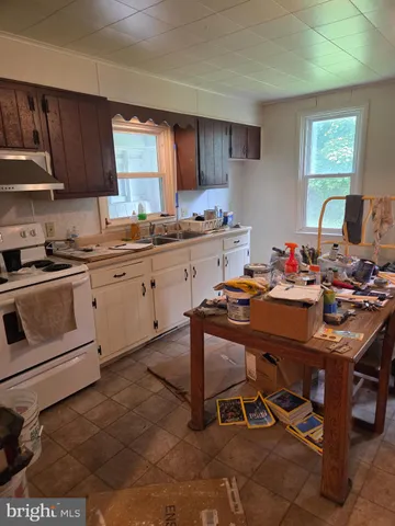 a kitchen with a sink stove and white cabinets