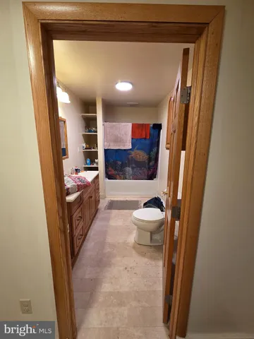 a bathroom with a sink and mirror with toilet