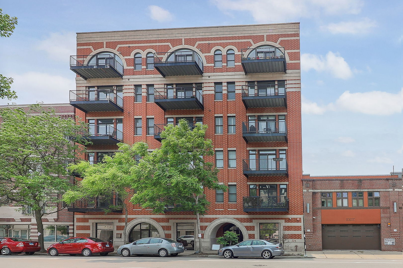 1355 West Washington Boulevard, Unit 4A Chicago, IL 60607 - Photo 1 of 24 a front view of a building and car parked