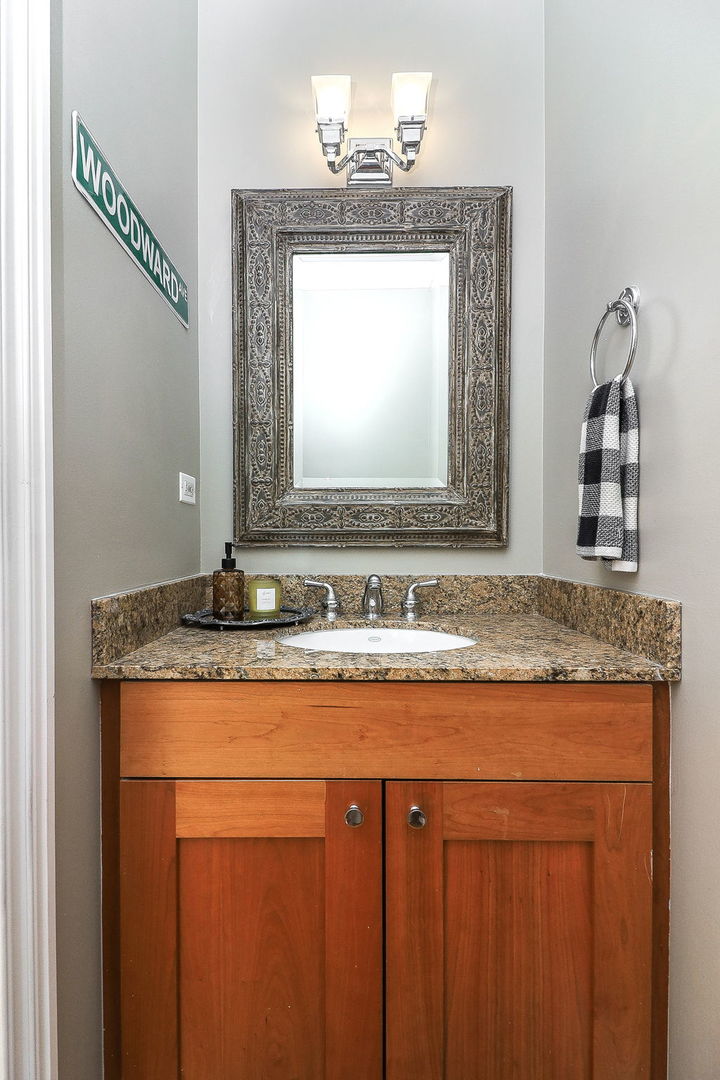 1355 West Washington Boulevard, Unit 4A Chicago, IL 60607 - Photo 12 of 24 a bathroom with a granite countertop sink and a mirror