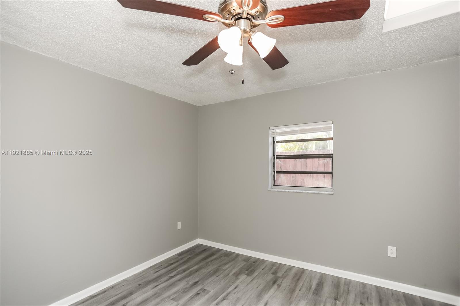 5835 Southwest 117th Avenue Miami, FL 33173 - Photo 12 of 16 an empty room with a window and a fan