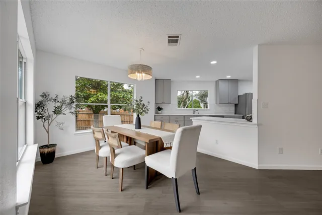 a view of a dining room with furniture and a large window