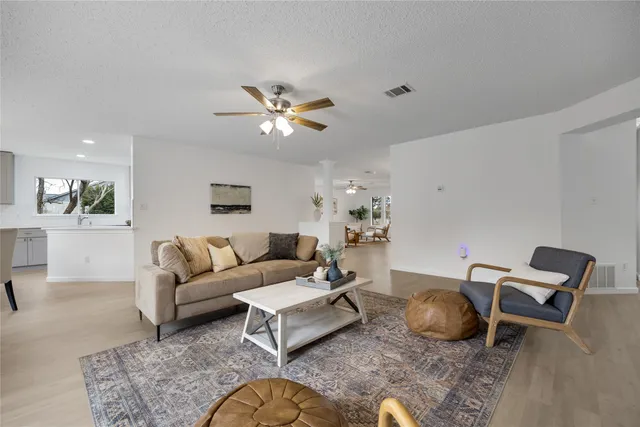 a living room with furniture a rug and a chandelier