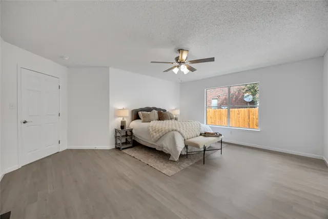 a spacious bedroom with a bed and window