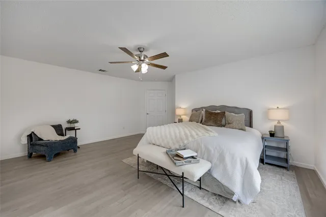 a bedroom with a bed and a chair