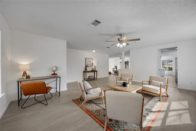 a living room with furniture and a chandelier