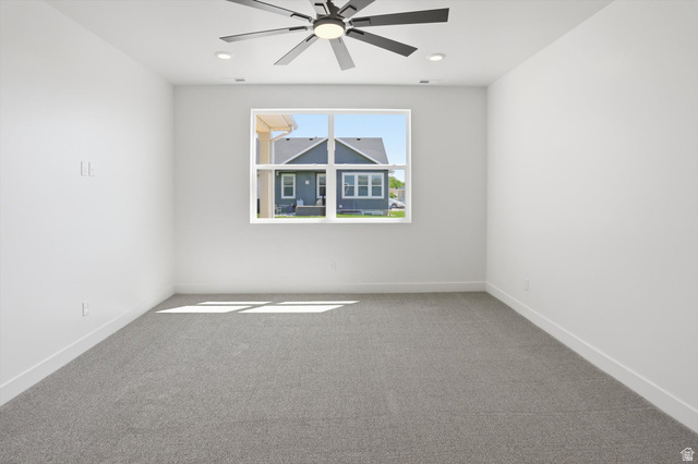 1315 West 3200 South, Unit 17 Perry, UT 84302 - Photo 30 of 58 Spacious room featuring neutral carpeting, a large window, a modern ceiling fan, and recessed lighting