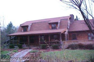 88 Butcher Road Falling Waters, WV 25419 - Photo 1 of 3 a front view of a house with garden
