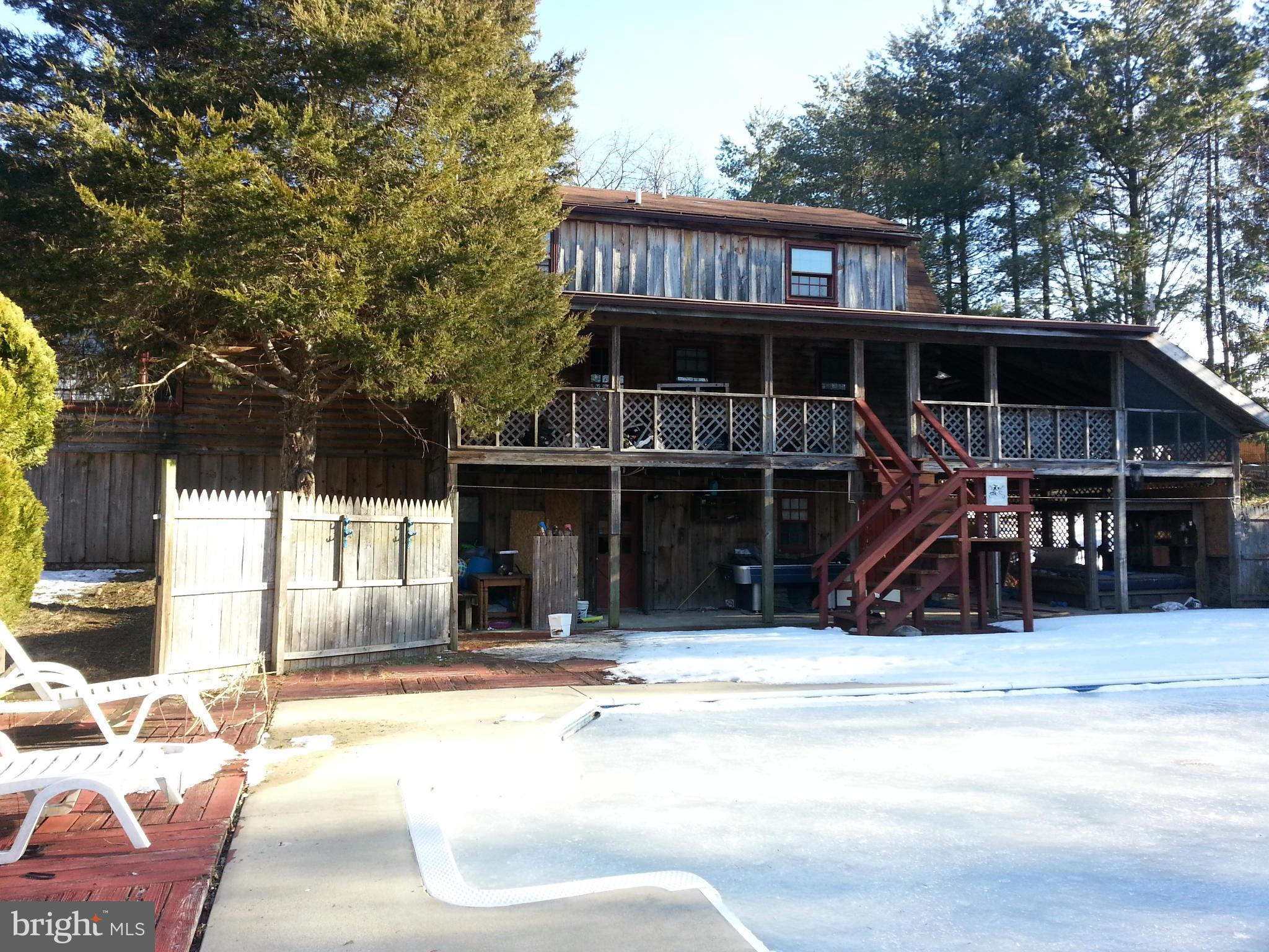 88 Butcher Road Falling Waters, WV 25419 - Photo 2 of 3 a view of a house with large windows and a wooden floor