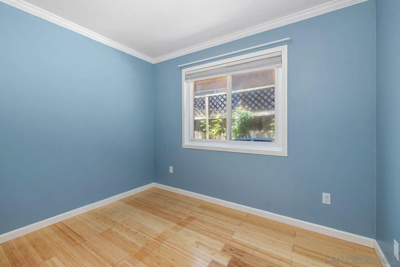 14215 Sutter Mill Way Poway, CA 92064 - Photo 20 of 38 a view of an empty room with wooden floor and a window