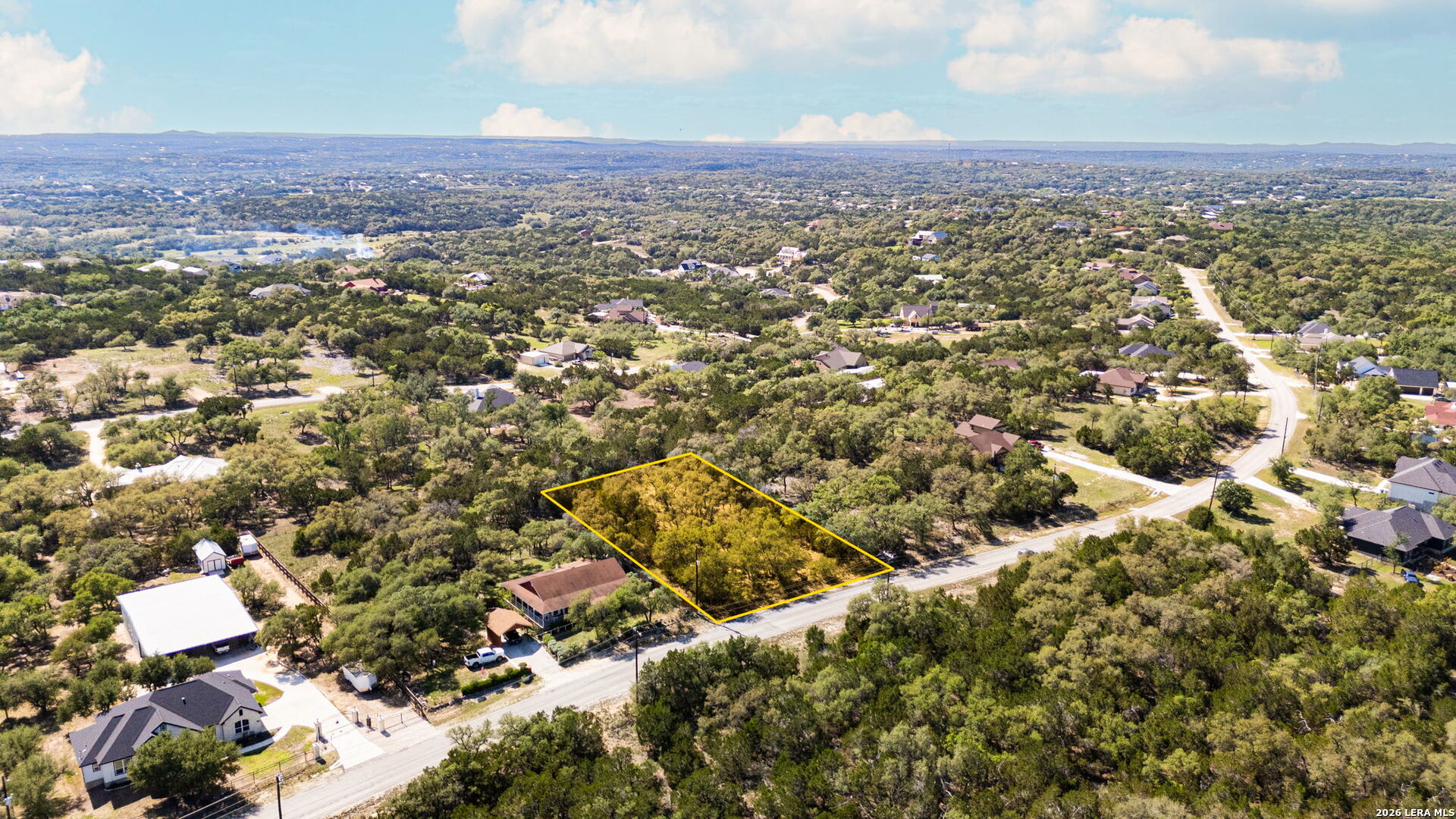 1158 Madrone Road Fischer, TX 78623 - Photo 2 of 8 an aerial view of residential house with yard and mountain view in back
