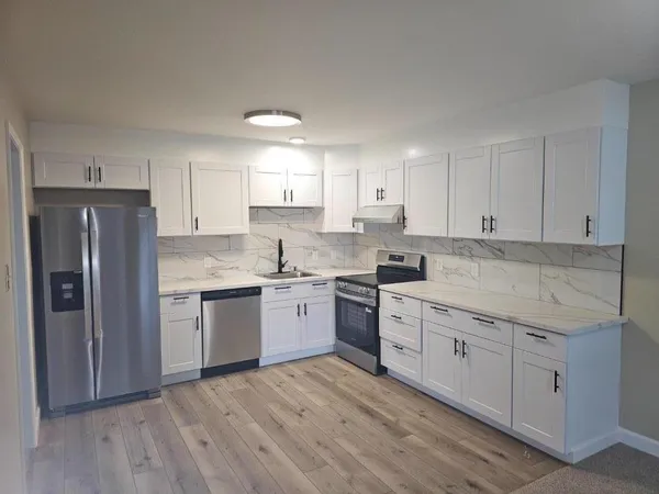 a kitchen with a sink stove and refrigerator