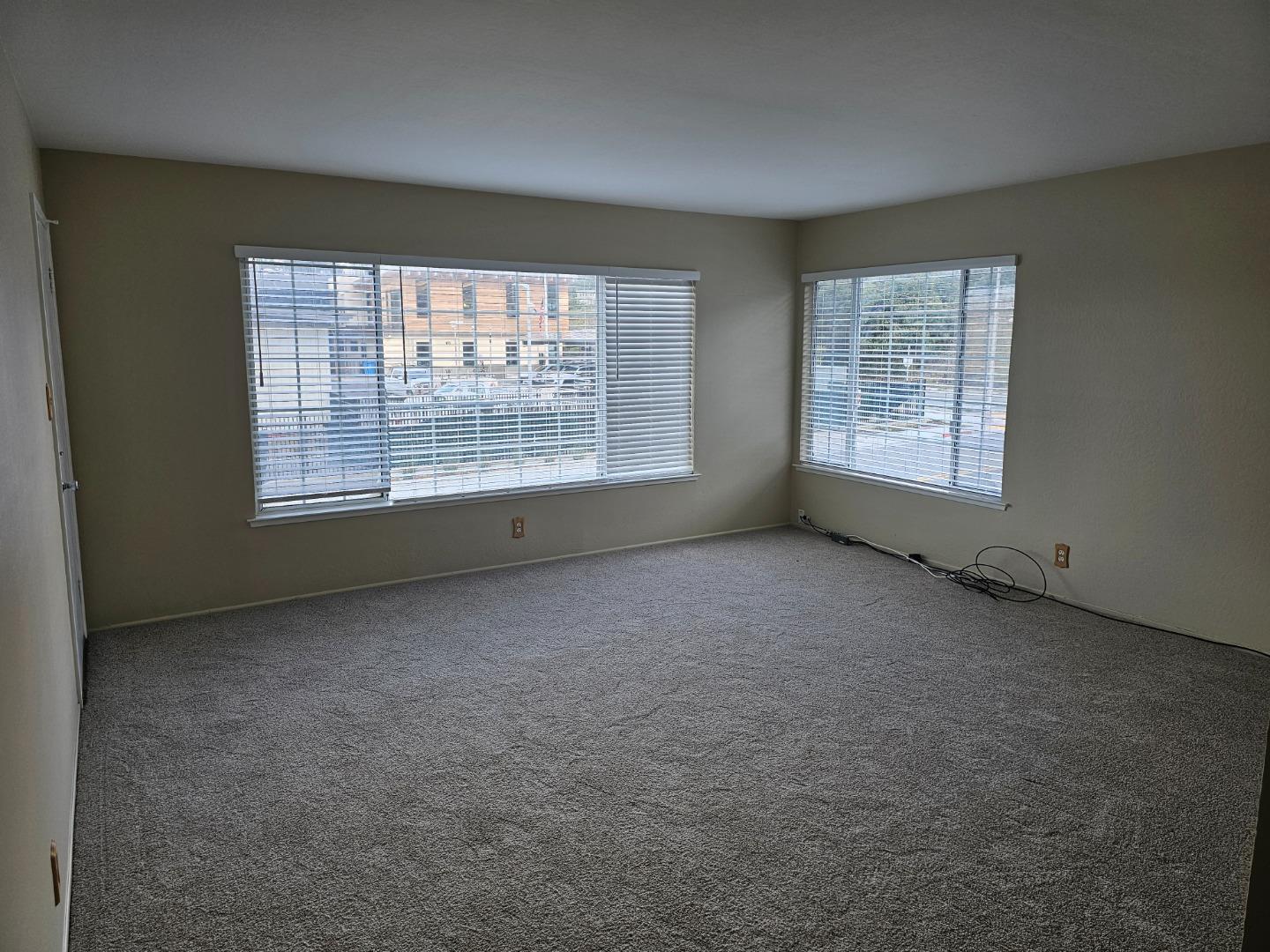 160 Clarendon Road, Unit A Pacifica, CA 94044 - Photo 4 of 13 an empty room with a empty space and windows