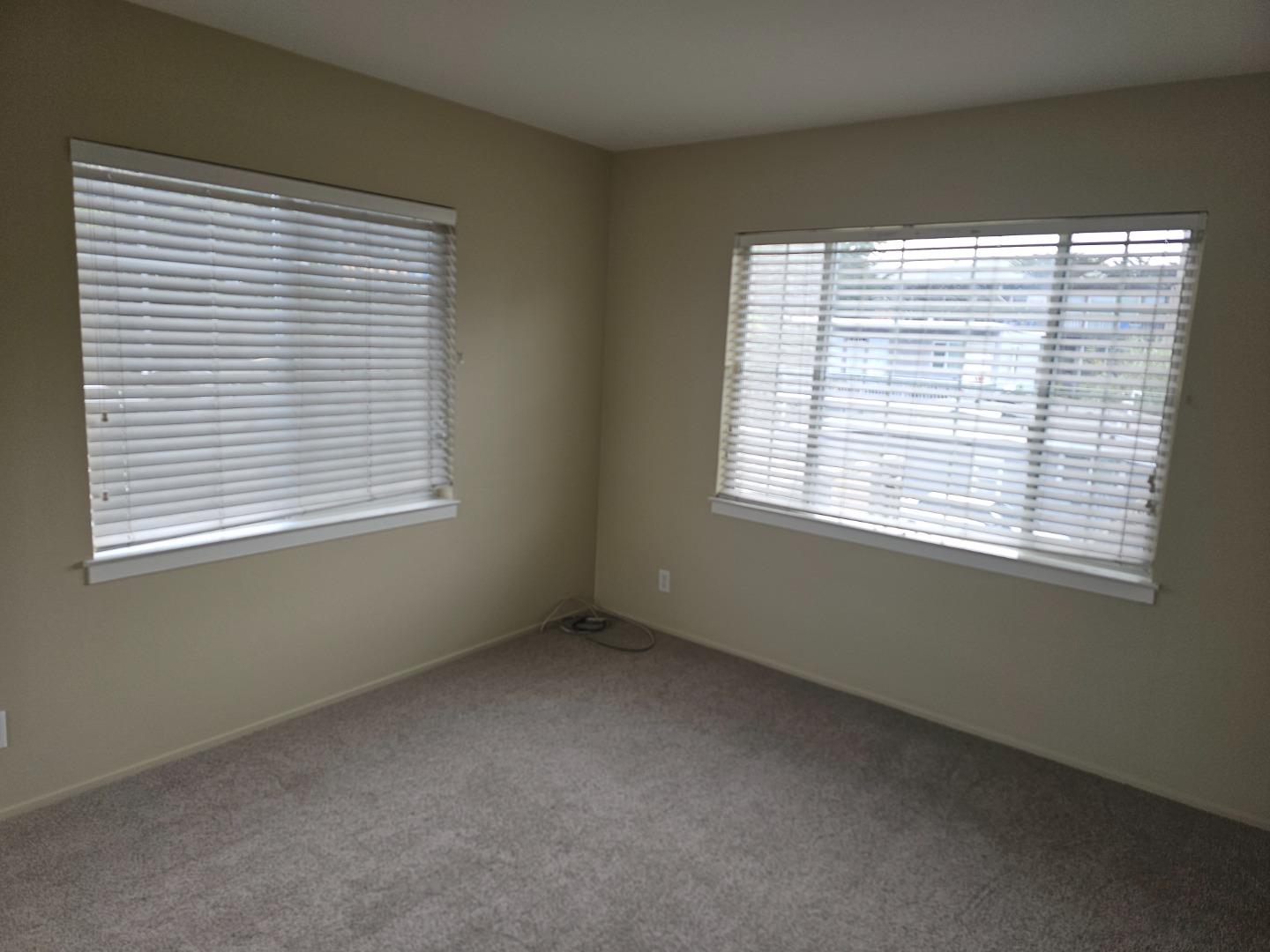 160 Clarendon Road, Unit A Pacifica, CA 94044 - Photo 9 of 13 a view of an empty room with a window