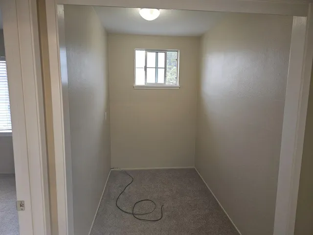 a view of a hallway with closet and wooden floor
