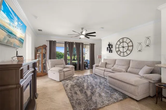 a living room with furniture a clock and a large window
