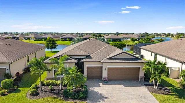 an aerial view of a house with a yard and potted plants