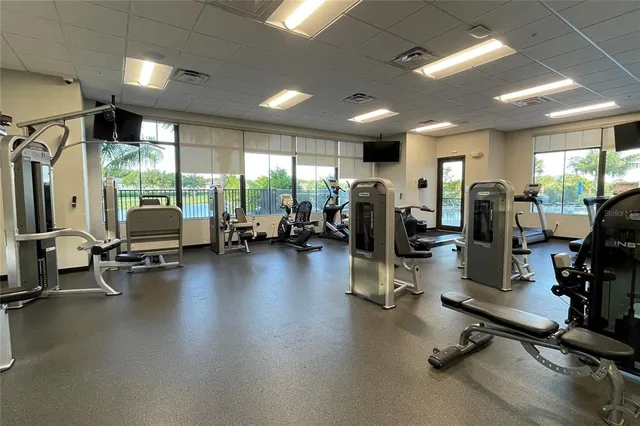 a view of an empty room with kitchen view and a window