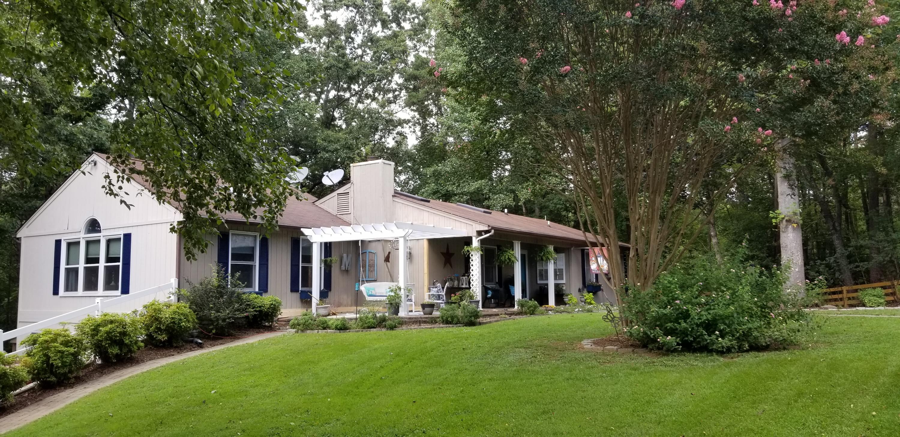 1317 Chandler Road Goodview, VA 24095 - Photo 1 of 29 a front view of a house with swimming pool having outdoor seating