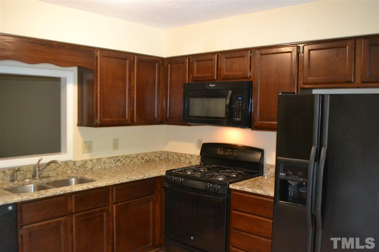 1513 Hemphill Drive Raleigh, NC 27609 - Photo 2 of 17 Beautiful granite countertops w/refinished cabinets and laminate flooring.
