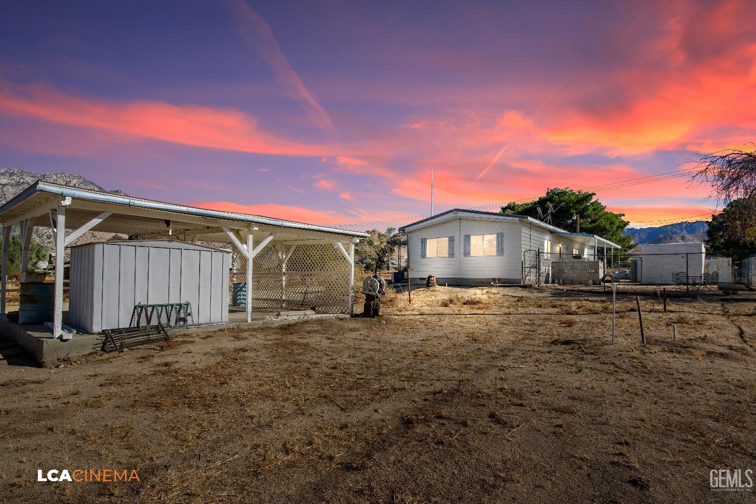 Undisclosed Address Onyx, CA 93255 - Photo 22 of 33 a front view of a house with a yard