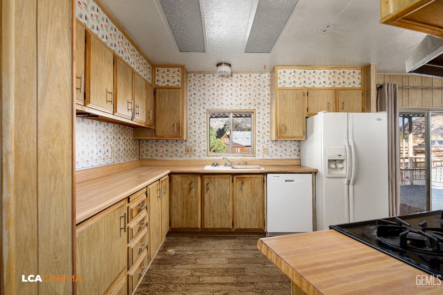 Undisclosed Address Onyx, CA 93255 - Photo 9 of 33 a kitchen with a refrigerator and a sink