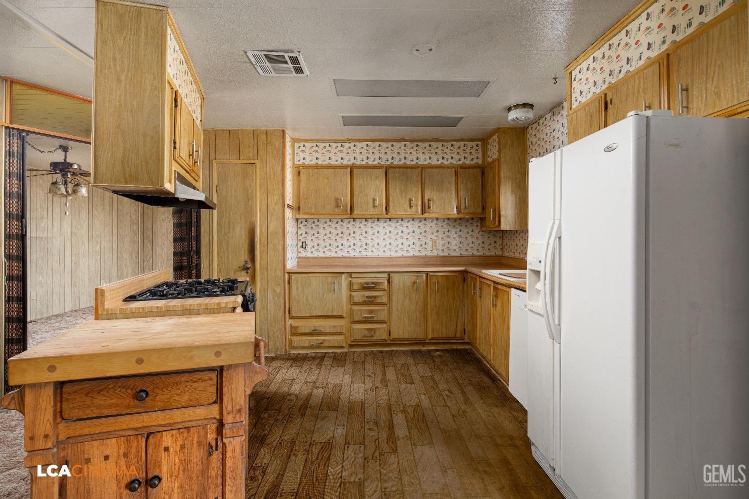 Undisclosed Address Onyx, CA 93255 - Photo 10 of 33 a kitchen with a refrigerator and a stove top oven