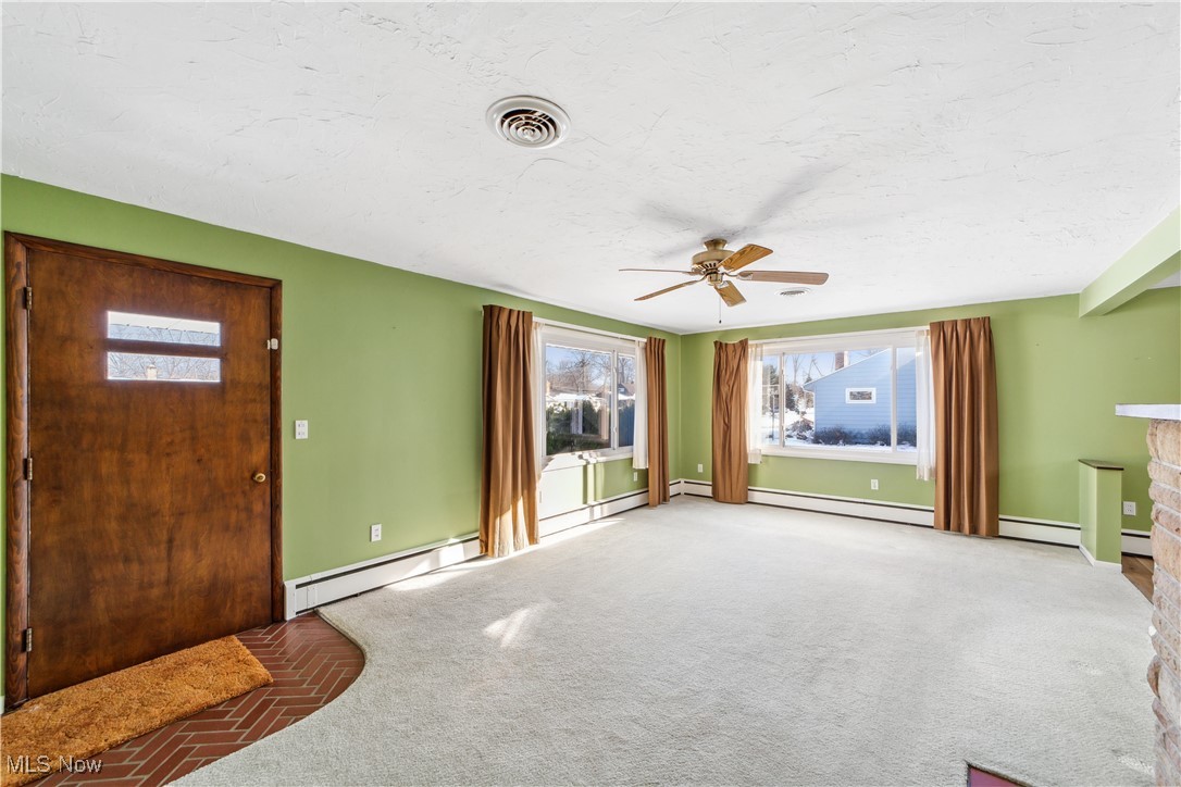 230 Fairfield Road Avon Lake, OH 44012 - Photo 3 of 40 Unfurnished living room with carpet floors and ceiling fan