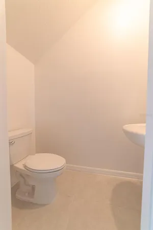 a white toilet sitting next to a white sink