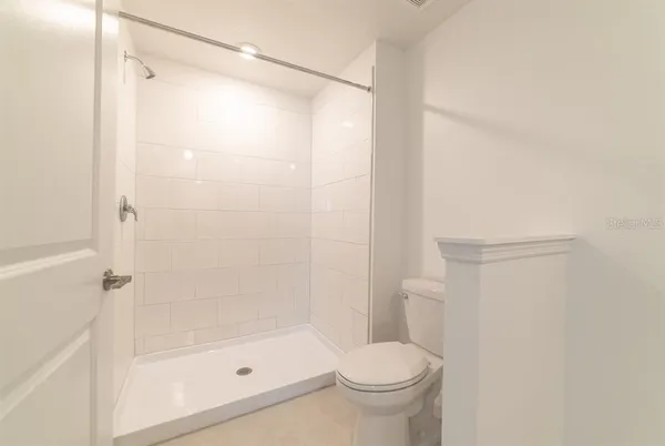 a bathroom with a shower and a toilet