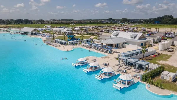 a picture of a city with lots of lake and houses in the back