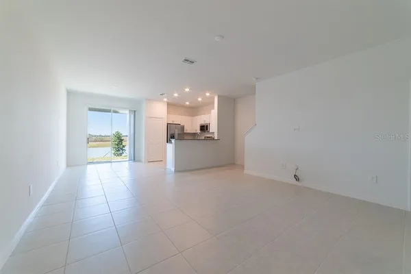 a view of a kitchen with a sink and a refrigerator