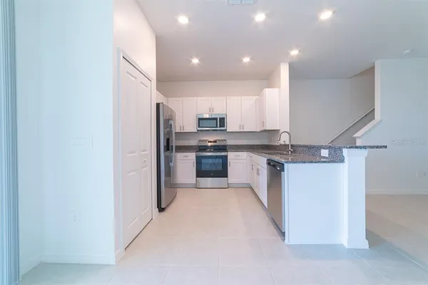 a kitchen with a refrigerator and a sink
