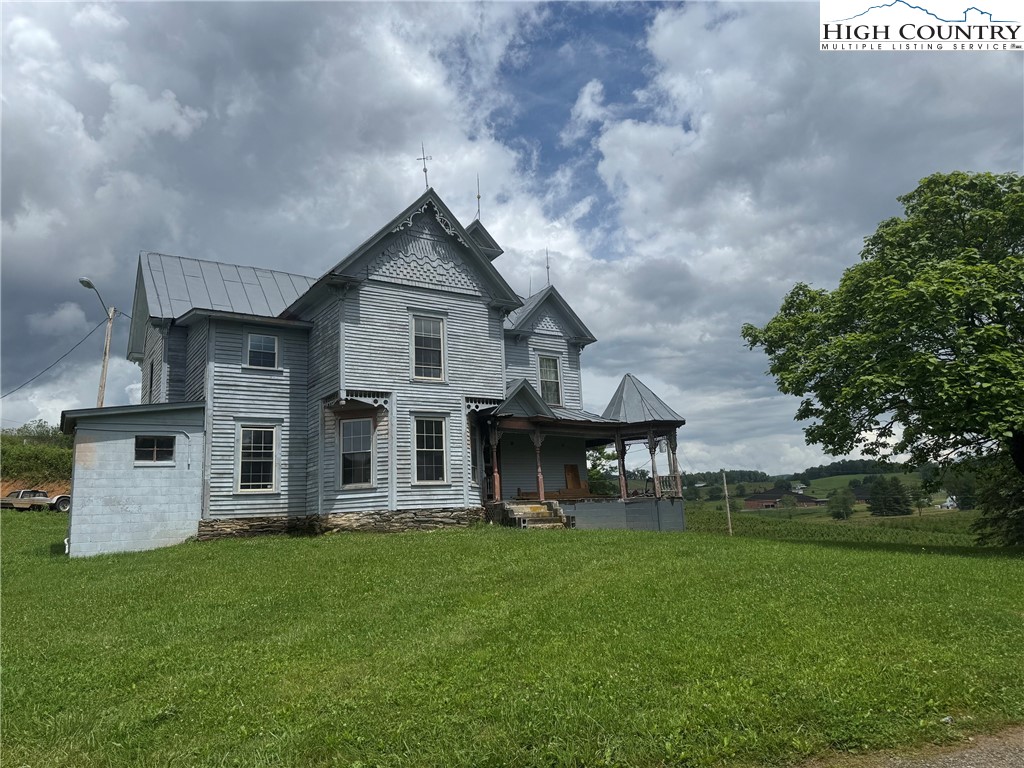 a view of a house with a yard and sitting area
