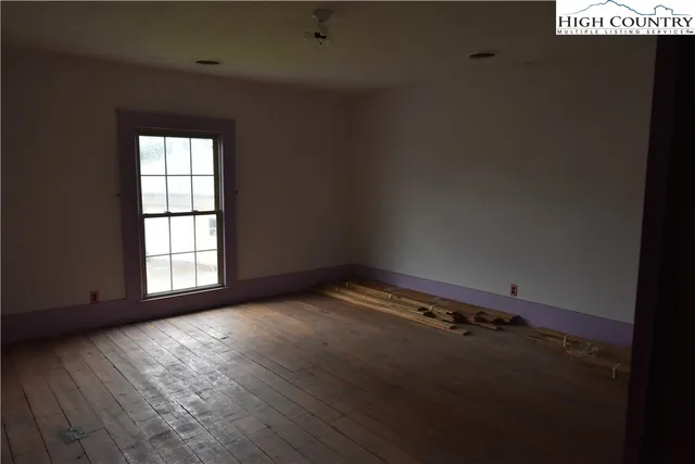 a view of a livingroom with furniture window and wooden floor