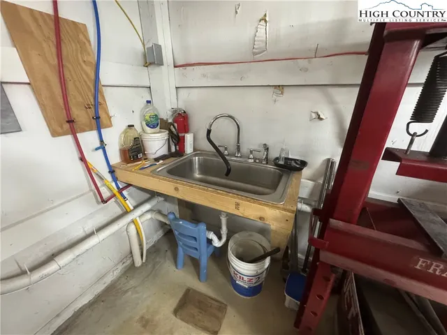 a view of gym equipment with wooden floor