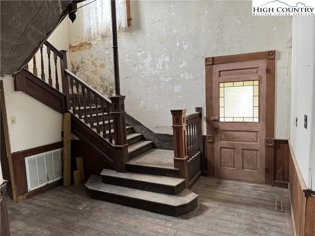 a kitchen with kitchen island granite countertop a sink counter top space and a view of living room