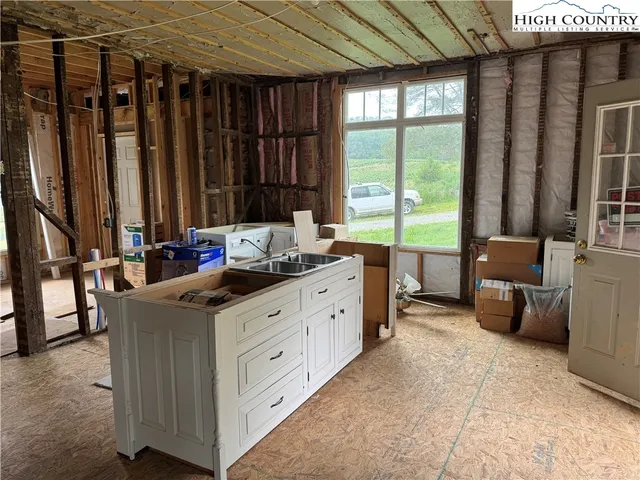 a kitchen with refrigerator and window