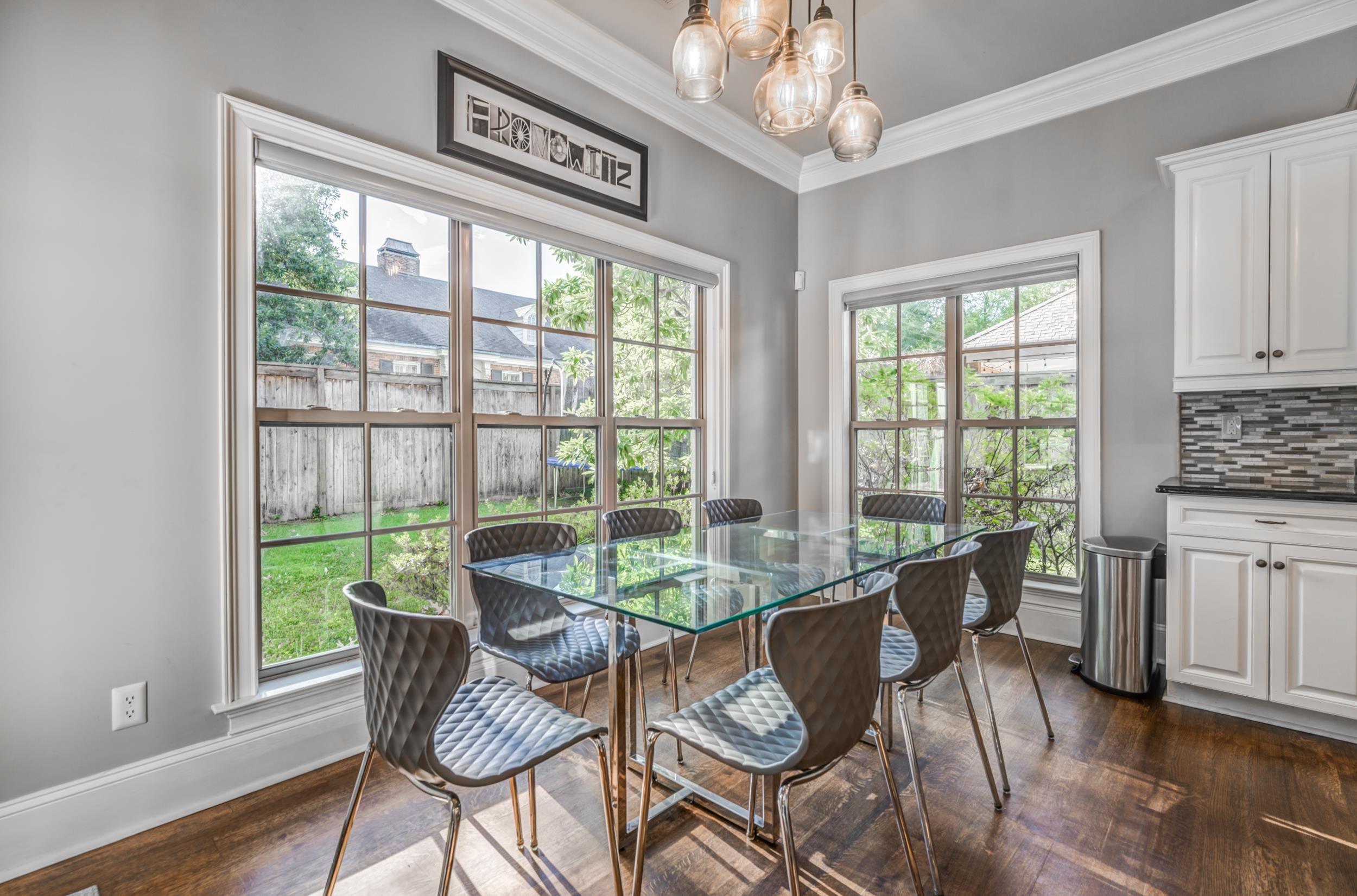477 South Yates Road Memphis, TN 38120 - Photo 19 of 39 a dining room with furniture a chandelier and wooden floor